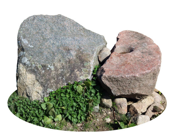 istock Big granite stones lie  on green grass isolated 1944279688