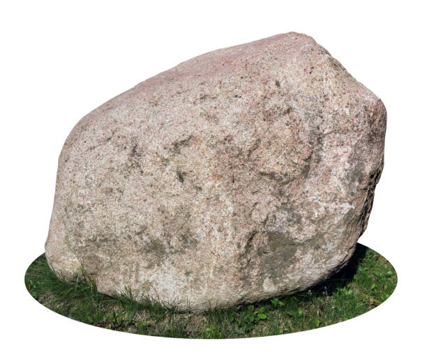 istock Big granite stone on green grass isolated 1944279689