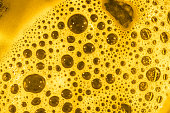 Yellow intense, vivid background - structure of round bubbles in bright foam