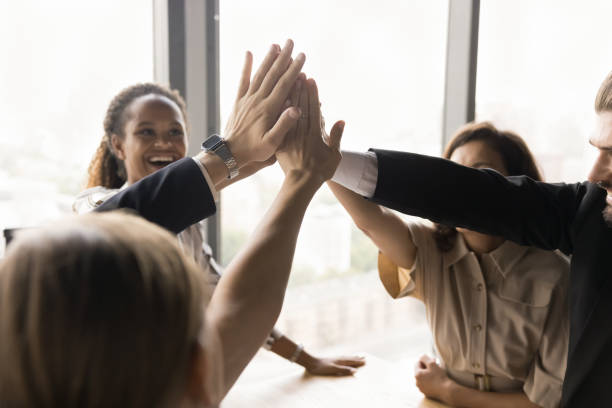 istock Cheerful business colleagues high five gesture close up 1944339662