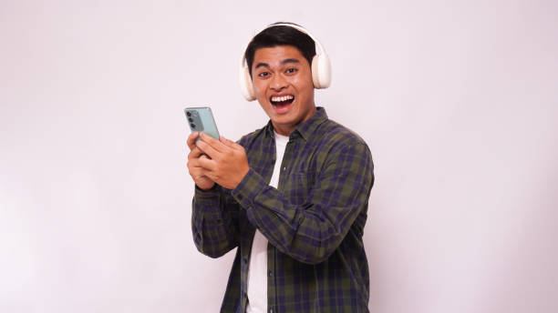istock Asian man listening music on smartphone using headphone wireless 1944344403