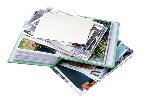 old family photo albums and photos heap isolated on white