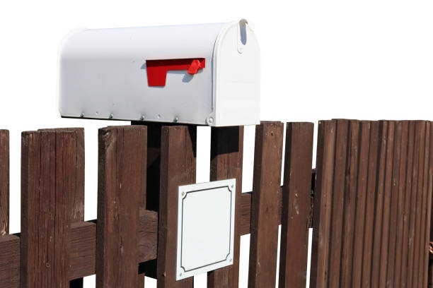 istock Metal mailbox mounted on a rustic  fence isolated 1944399813