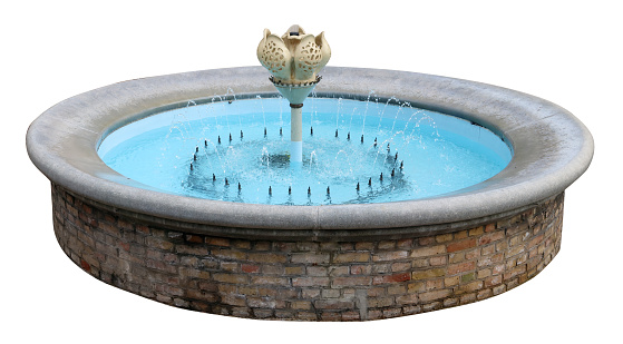 Small round fountain with blue water isolated on white