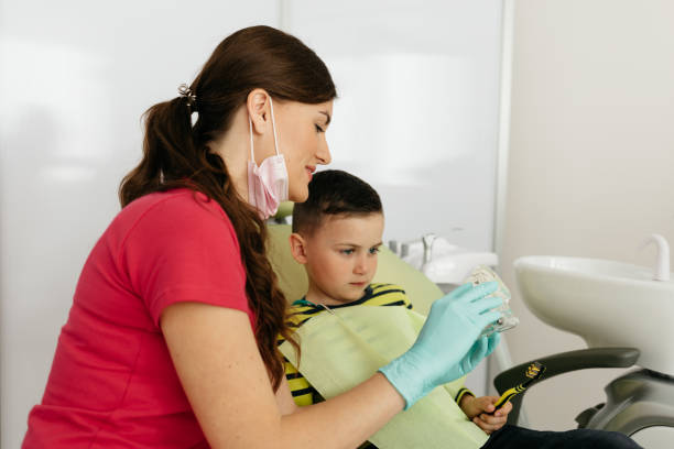 istock Dentist is teaching little boy about oral hygiene. 1944401903