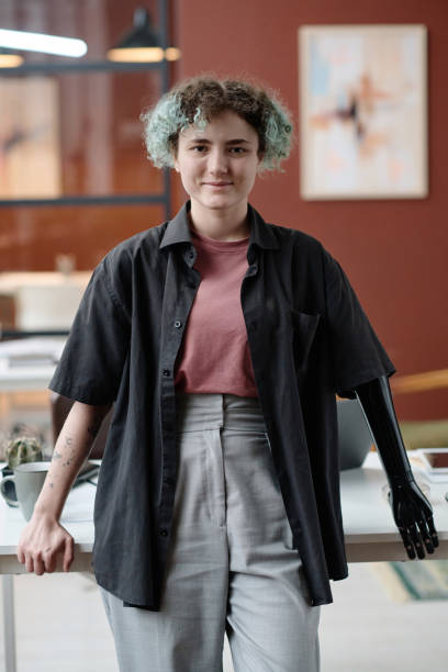 istock Female Office Worker with Prosthetic Arm Posing at Her Workplace 1944413429