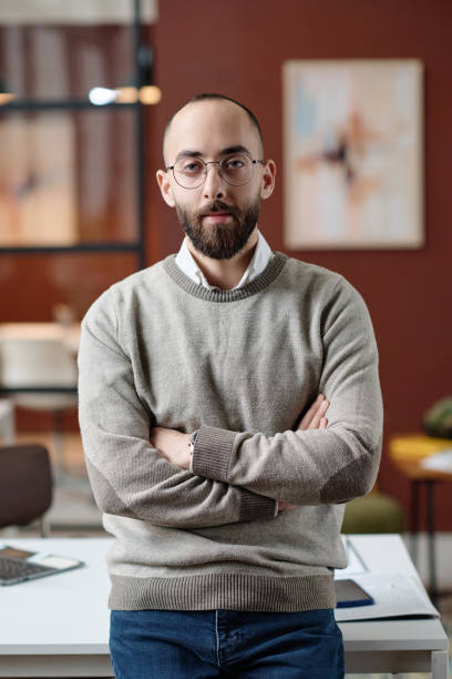 istock Serious Male Office Worker Standing by His Desk 1944413445