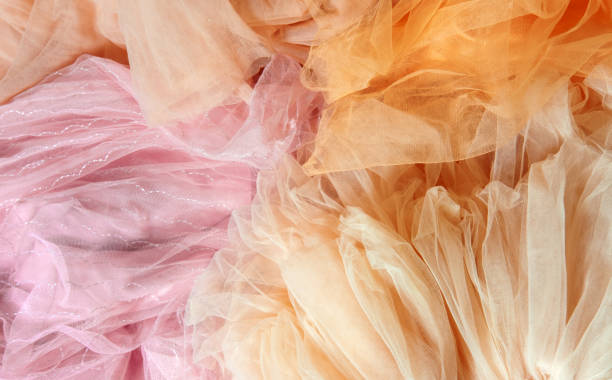 istock Top view abstract background of crumpled peach and pink chiffon. 1944435352