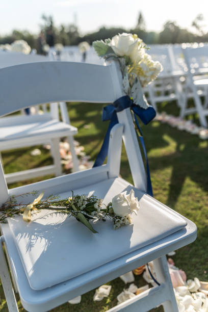 istock Empty seat with white flowers at an outdoor wedding ceremony 1944435548