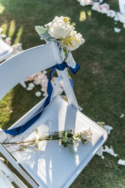 istock Empty seat with white flowers at an outdoor wedding ceremony 1944435564
