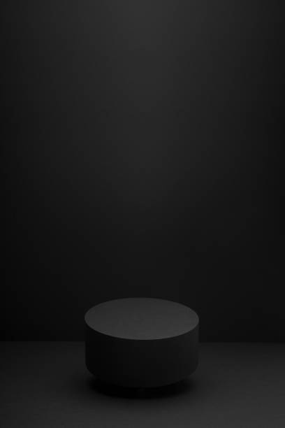 istock Flying black round podium, mockup on black background with shadow, vertical. Scene template for presentation cosmetic products, gifts, goods, advertising, design, display, showing in minimalist style. 1944436110