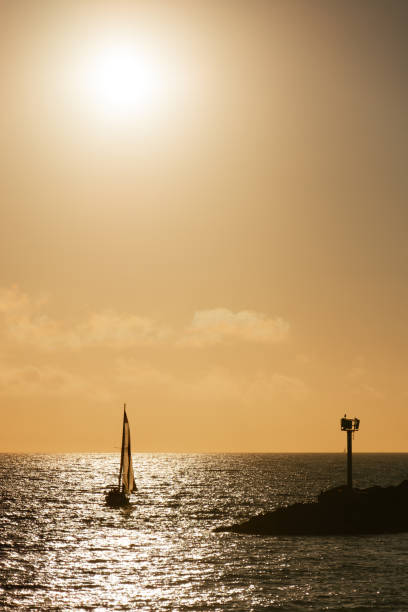 istock Sailboat glides gracefully in the tranquil waters at sunset 1944436111