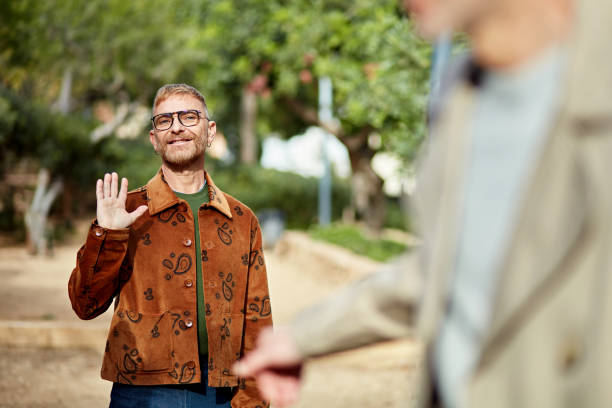 istock Mature men waving goodbye after day date 1944442037