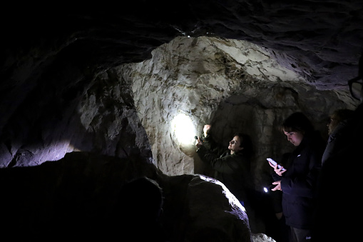 Cuenca, Castile-La Mancha, Spain- December 10, 2023: People visiting the Lapis Specularis roman mine in The Sanabrio caves in Cuenca region, Spain