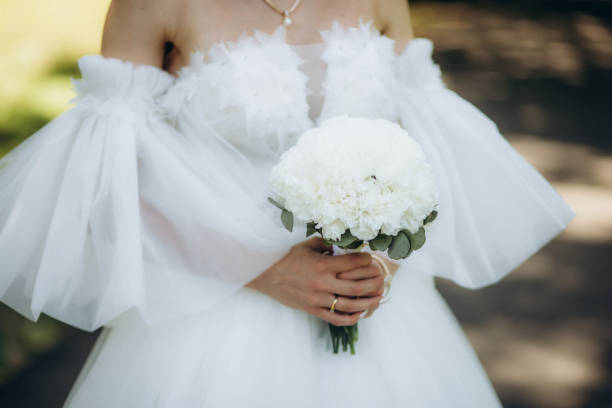 istock bride holding gentle wedding bouquet 1944472849