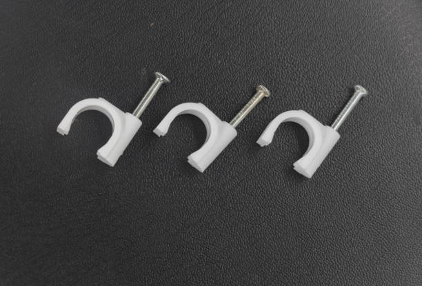 wiring nail or wiring stud plastic card or Round Cable Clips isolated on black background.