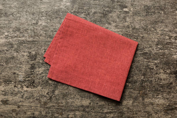 istock top view with red empty kitchen napkin isolated on table background. Folded cloth for mockup with copy space, Flat lay. Minimal style 1944496272