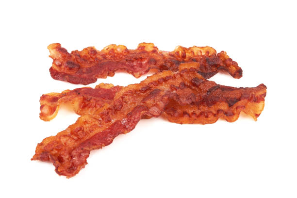Cooked slices of bacon isolated on white