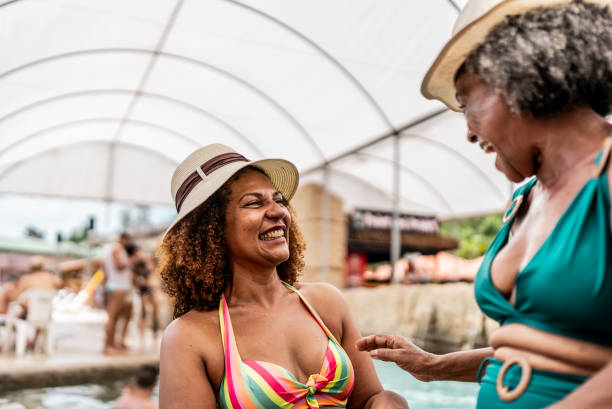 istock Mother and daughter talking at water park 1944523018