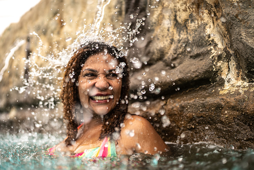 Mature woman bathing at water park swimming pool