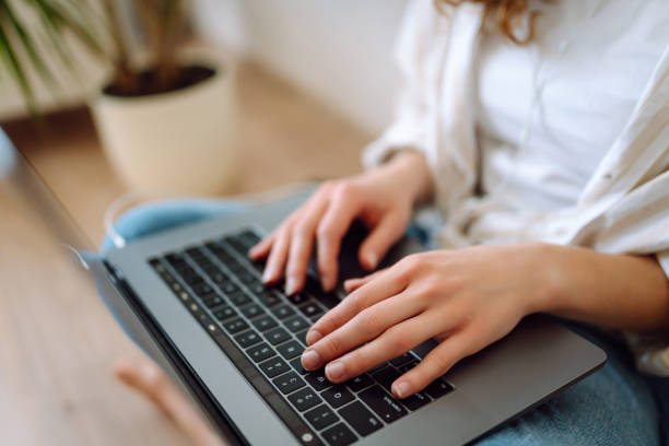 istock Close-up of hands working on a laptop keyboard. 1944528878