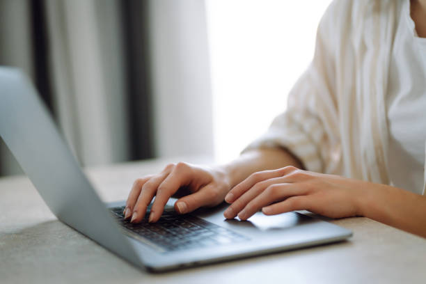 istock Close-up of hands working on a laptop keyboard. 1944528887