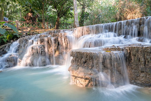 Kuang Si Waterfall in the morning at Luang prabang,Laos. Waterfalls from limestone mountains give the water a beautiful clear blue color.