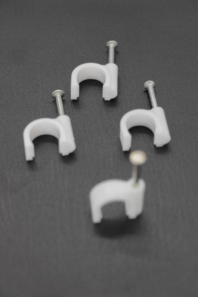 wiring nail or wiring stud plastic card or Round Cable Clips isolated on black background