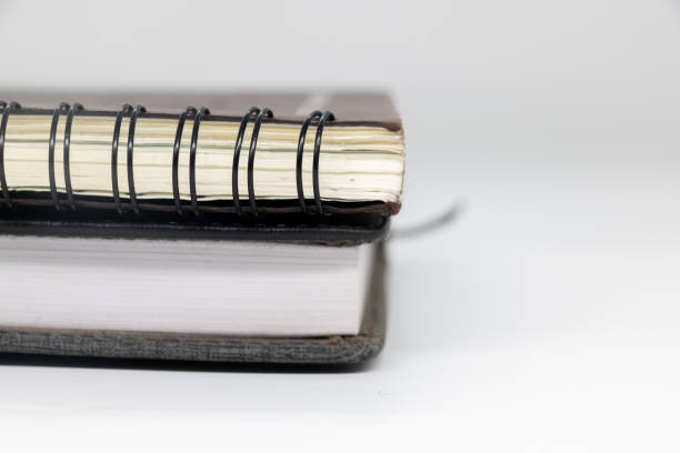 istock black notebook on white background with clipping path writing in spiral notepad on isolated. 1944533089