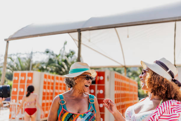 istock Mother and daughter talking at water park 1944533102