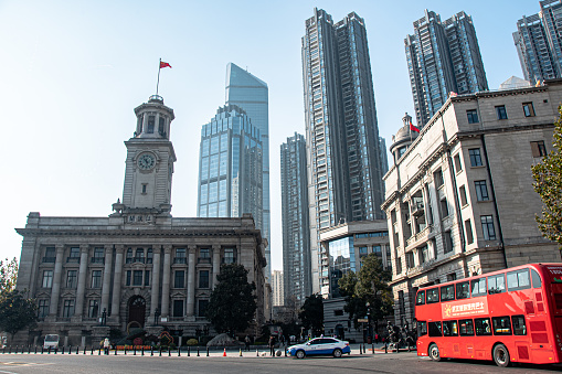 Wuhan, China – December 23, 2023: A red double-decker bus passing by tall buildings in Wuhan, China