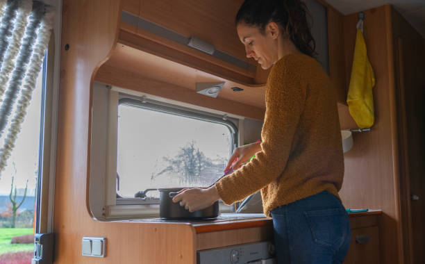 istock Woman cooking inside a motorhome 1944546894