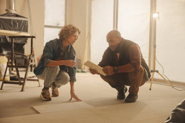 istock Mature home improvement team discussing floor remodeling for their kitchen 1944556953