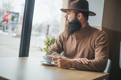 bearded young man enjoying coffee
