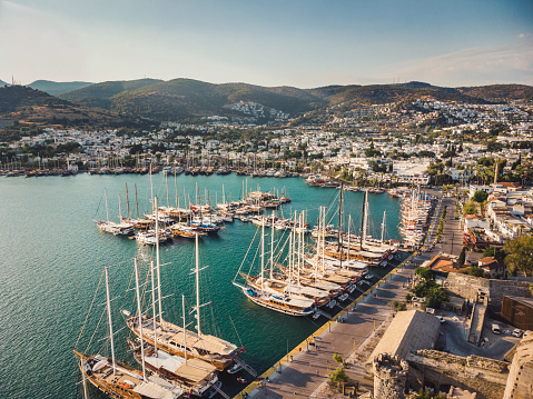 Bodrum Cruise Port southwestern Aegean sea harbor. A stunning view of sailing yachts in Port. Yachts in sunset bay. Sailing boats sunset scene. Sunset yachts view. Yachts in sunset bay.