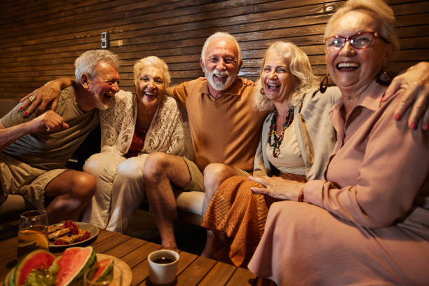 istock Group of cheerful seniors embracing on a patio. 1944568504