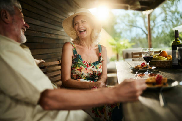 istock Happy mature couple talking at picnic table on the backyard. 1944571195