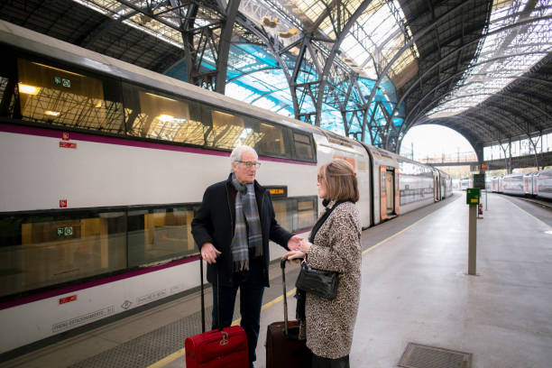 istock Senior couple at train station 1944583692