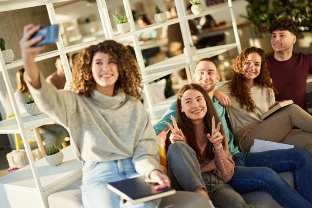 istock Happy college students taking a selfie with cell phone at campus. 1944592374