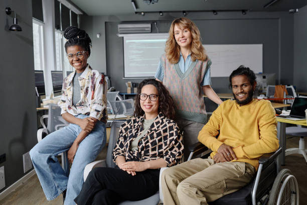 istock Group of Young Cheerful Programmers Posing Together at Their Workplace 1944610992