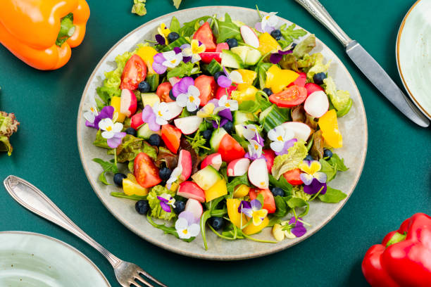 Vegetable salad decorated with flowers. stock photo