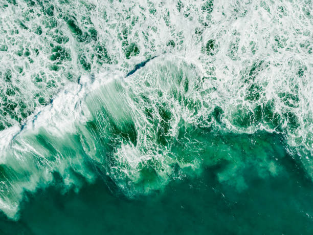 Large waves of turquoise rough sea from above