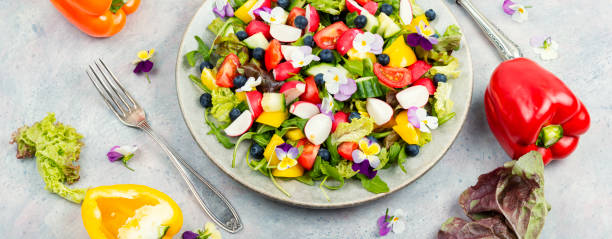 istock Spring salad with vegetables and flowers. 1944617342