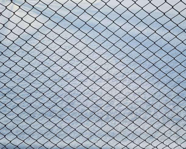 istock Metal mesh and white snow 1944617345