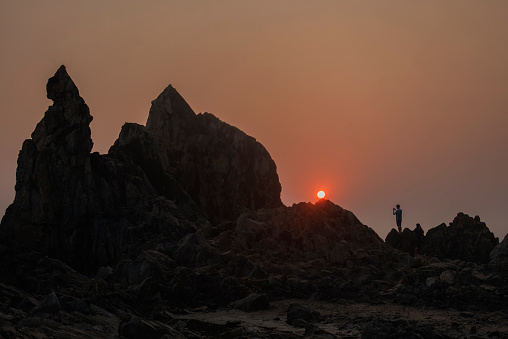 Rock formation with beautiful sunset at Arambhol beach, Goa. Background. Backdrop. Wallpaper.