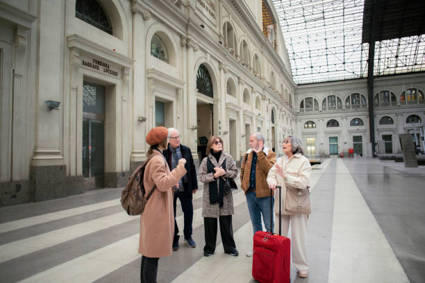 istock Senior friends with a tour guide at the train station 1944633596