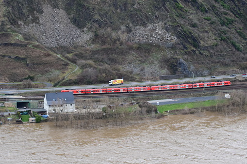 Andernach, Germany - 01/05/2024: train and truck slightly above the flood of the Rhine