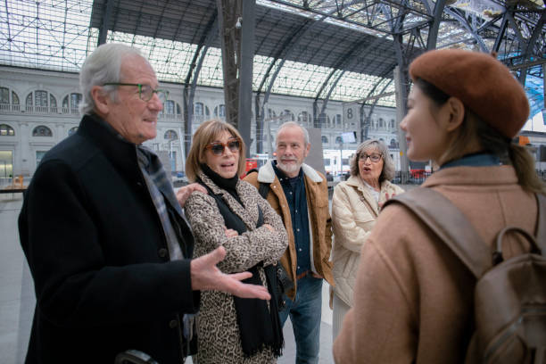 istock Senior friends with a tour guide at the train station 1944640073