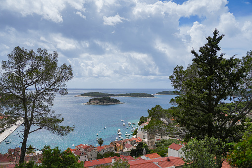 Stunning view of Sivota village and it's bay - Lefkada island in Greece. In front are the olive trees and in distance is Atokos island.
