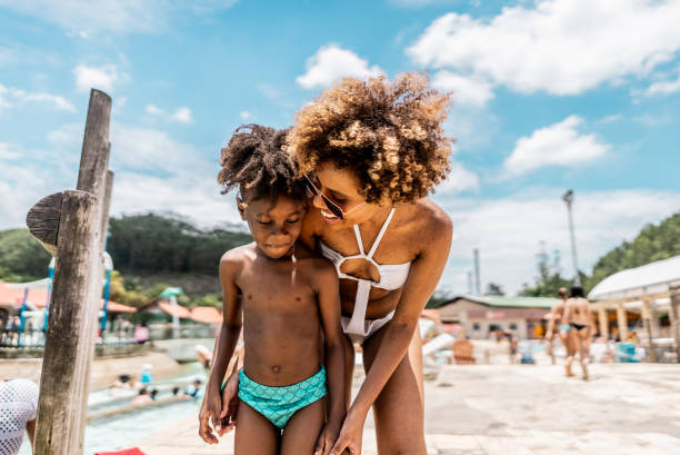 istock Mother talking with son at water park 1944666924